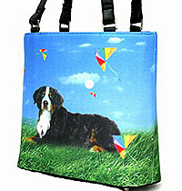 Bernese Mountain Dog Purse 1 is a Microfiber Bernese bucket handbag features a beautiful Bernese Mountain dog against a blue sky and green grass background. Measures 10.50" X 9.50" (26.67 X 24.13 cm)