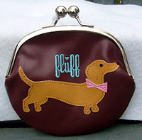 Dachshund Coin Purse features a cute Dachshund on the brown side and a chocolate Dachshund with an aqua background on the other side. Measures 5.50" X 5.50" (13.335 X 13.335 cm).