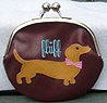 Dachshund Coin Purse 1 - This coin purse features a cute Dachshund on the brown side and a chocolate Dachshund with an aqua background on the other side.Measures 5.50" X 5.50" (13.335 X 13.335 cm).