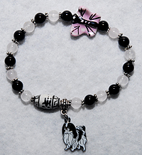 Japanese Chin Bracelet 1 features genuine Onyx and rose Quartz beads culminate to a delicate pink and black porcelain butterfly and are completed with a black and white Japanese Chin charm.