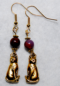 Kitty Earrings 2 features gold pewter kitty charms with genuine Aqua Terra Jasper gemstone beads. The beads are a deep red-purple.