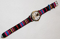 Pug Watch 4 - Pug Watch 4 comes with a multi-colored canvas type striped band and fob featuring a sweet, fawn Pug. 