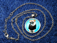 Pug Necklace 2b - Round pendant with fawn Pug on aqua background dressed in a black tee shirt.